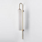 Glass wall sconce shown with warm bulb glow through the glass