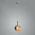 Clear glass globe pendant light glowing in a dim room
