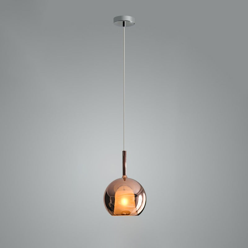 Clear glass globe pendant light glowing in a dim room