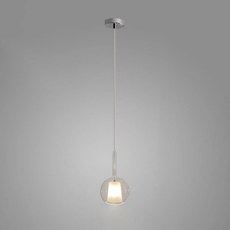 Glo blown glass globe pendant light hanging over a table