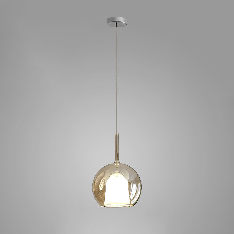 Smoke gray glass globe pendant light over a dining table