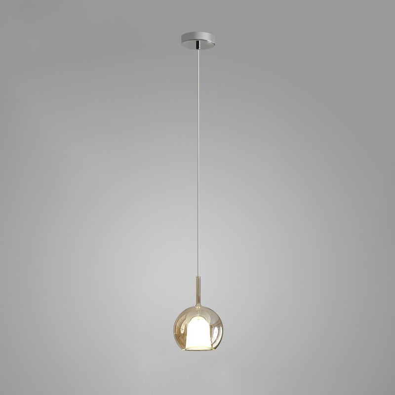 Tinted blown glass globe pendant light with soft warm glow