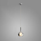 Amber glass globe pendant light glowing above a kitchen island