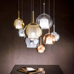 Tinted blown glass globe pendant light with warm sculptural glow