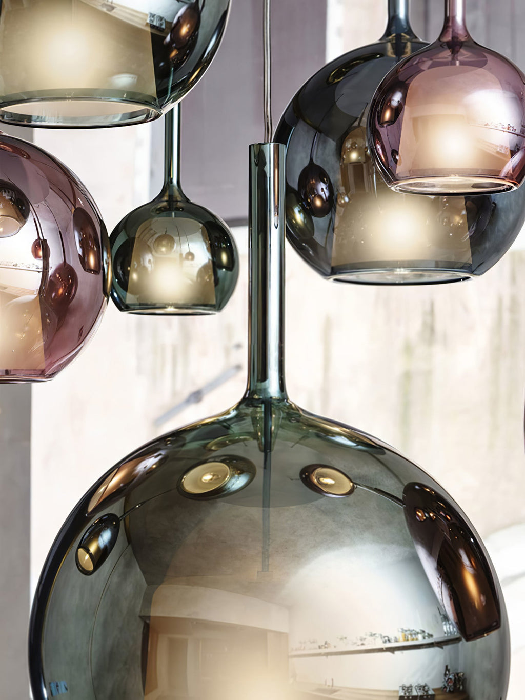 Tinted glass globe pendant light hanging in a warm interior