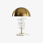 Globo table lamp lit on a side table with white marble base