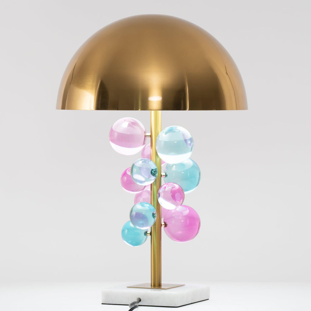 Globo table lamp glowing warm against a dark interior backdrop