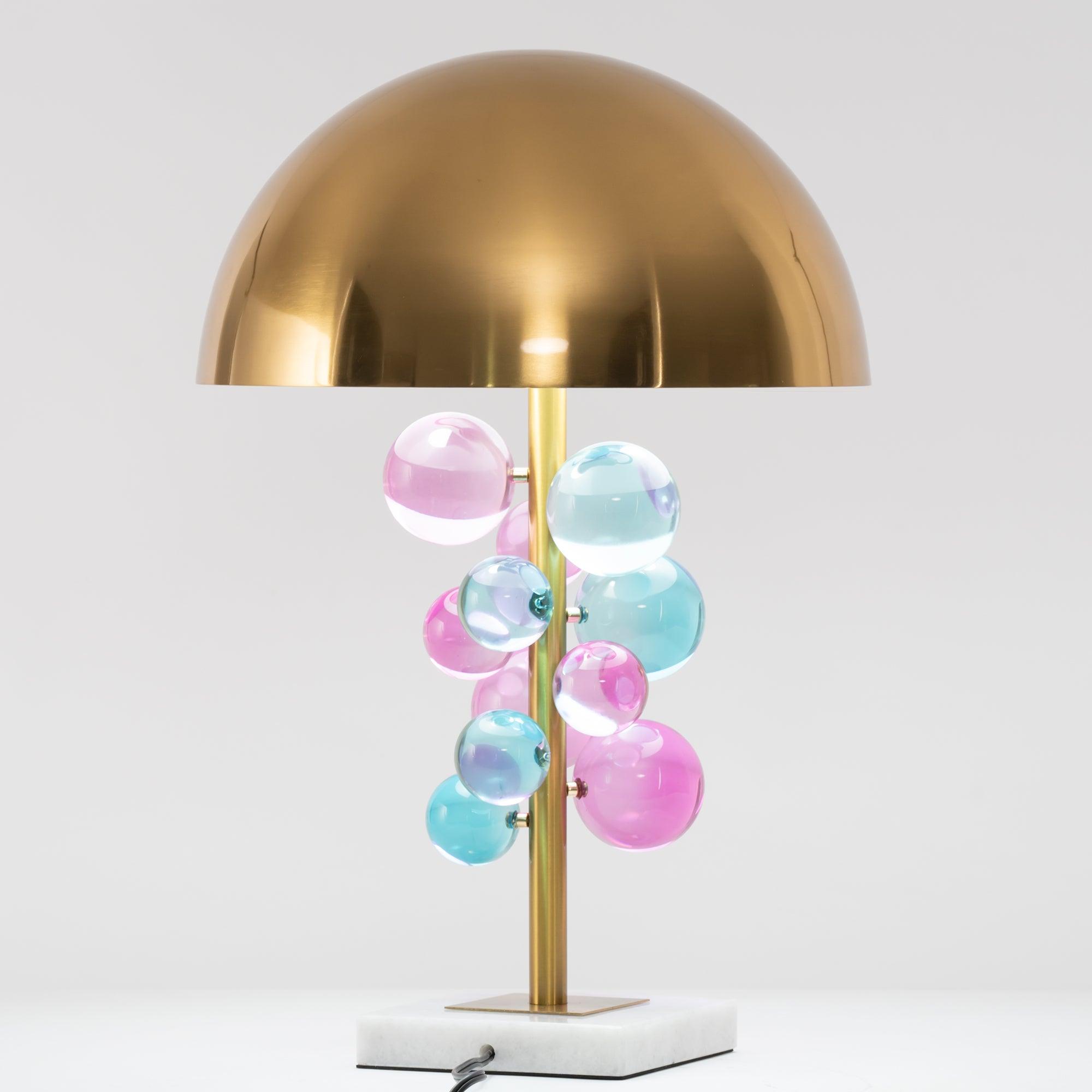 Globo table lamp glowing warm against a dark interior backdrop