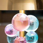 Globo table lamp lit with a soft warm glow on a tabletop