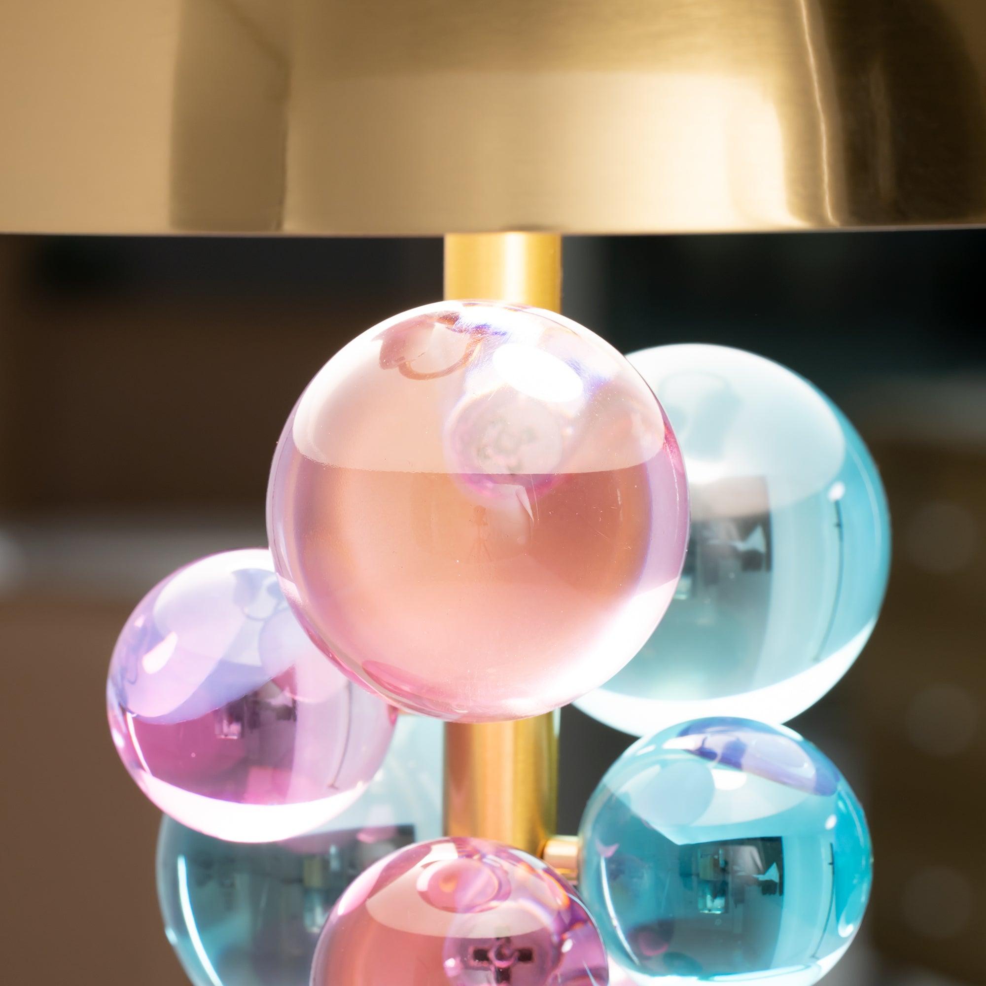 Globo table lamp lit with a soft warm glow on a tabletop