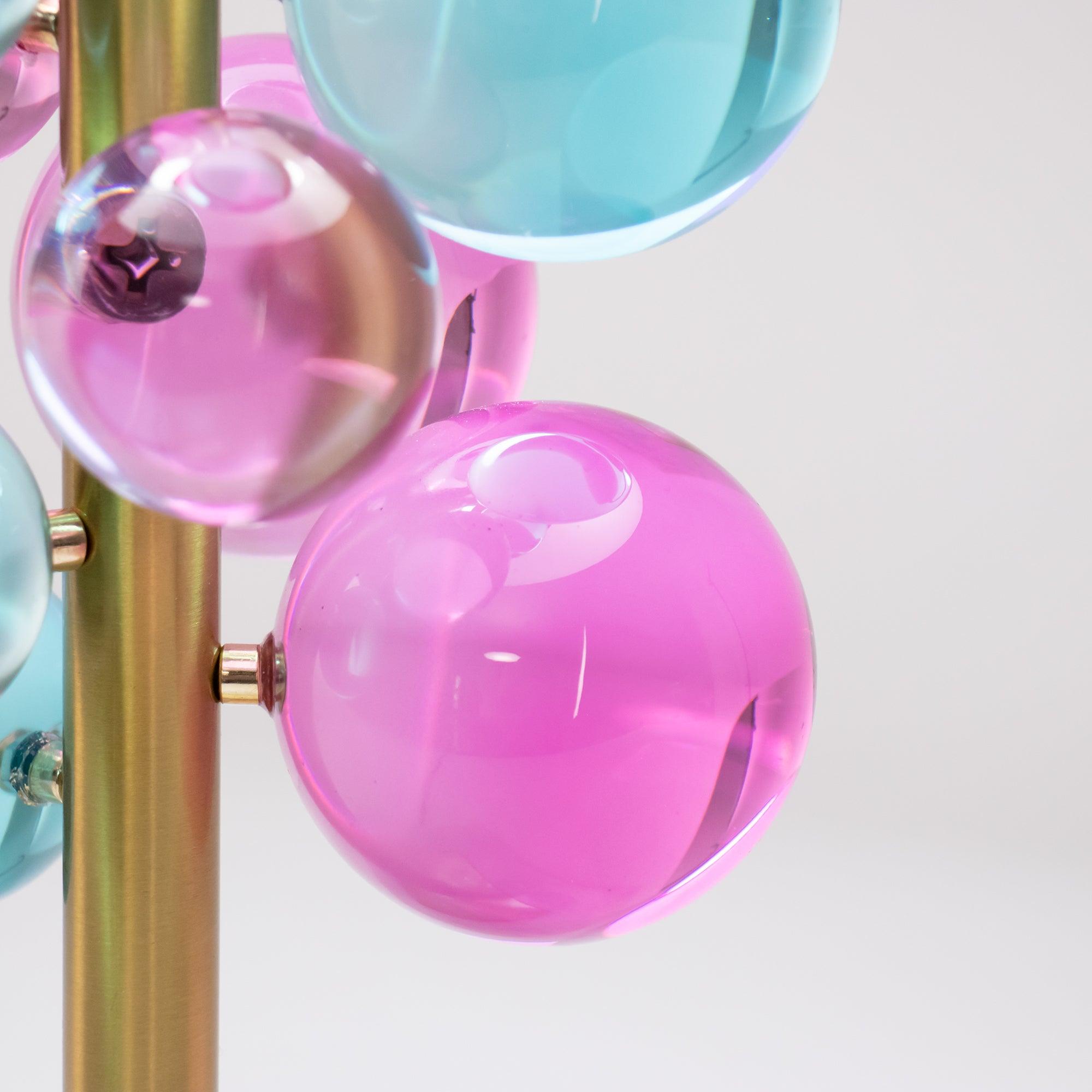 Globo table lamp lit on a surface with warm refracted light