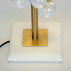 Globo table lamp gold stem and glass spheres close detail view