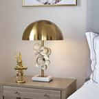Glass sphere table lamp casting sparkling light across a surface