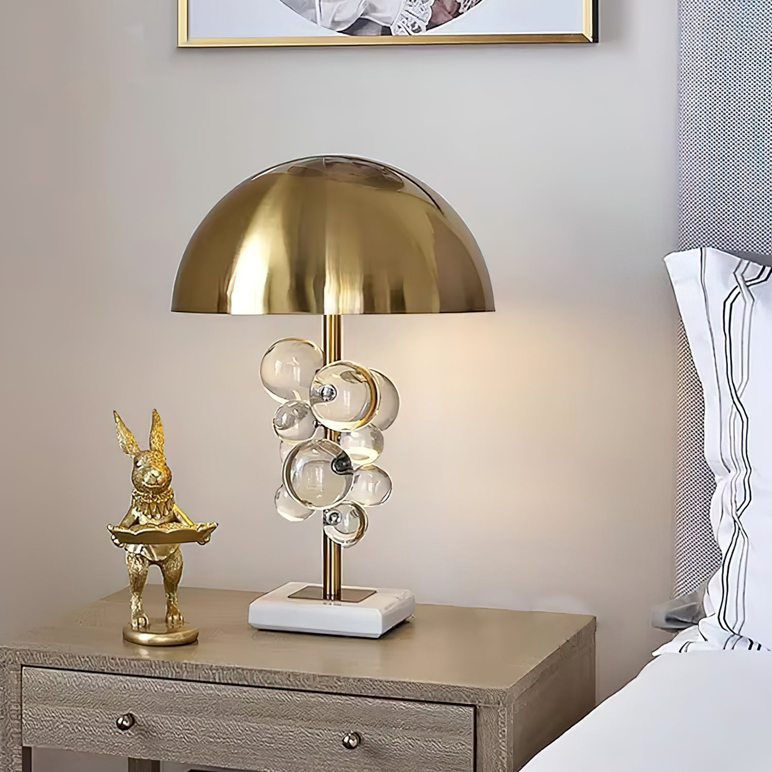 Glass sphere table lamp casting sparkling light across a surface