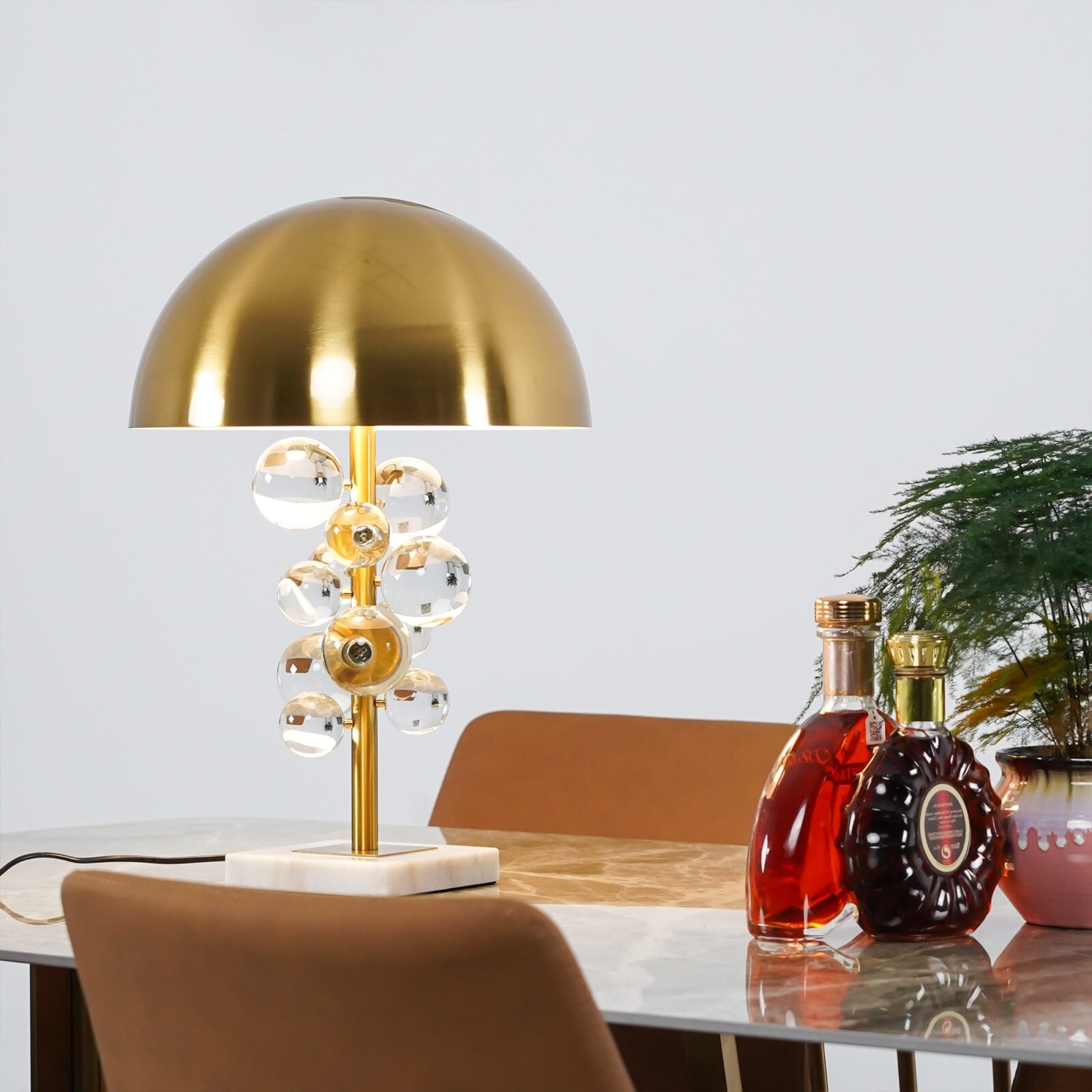 Detail of glass spheres clustered on the slender gold lamp stem