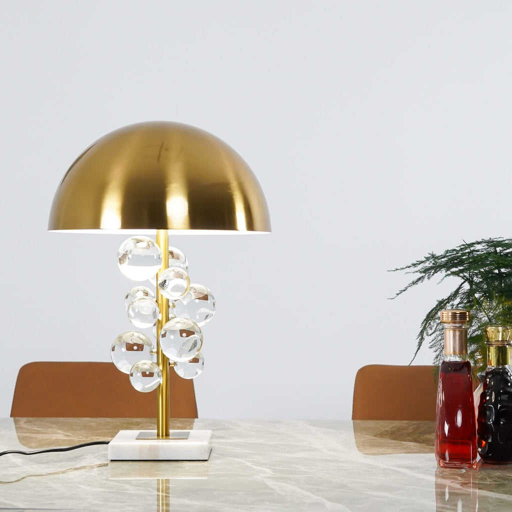 Glass sphere table lamp glowing warm in a softly lit room