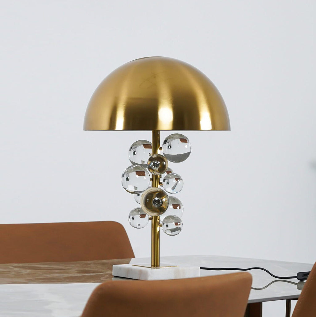 Globo glass sphere table lamp glowing on a marble base