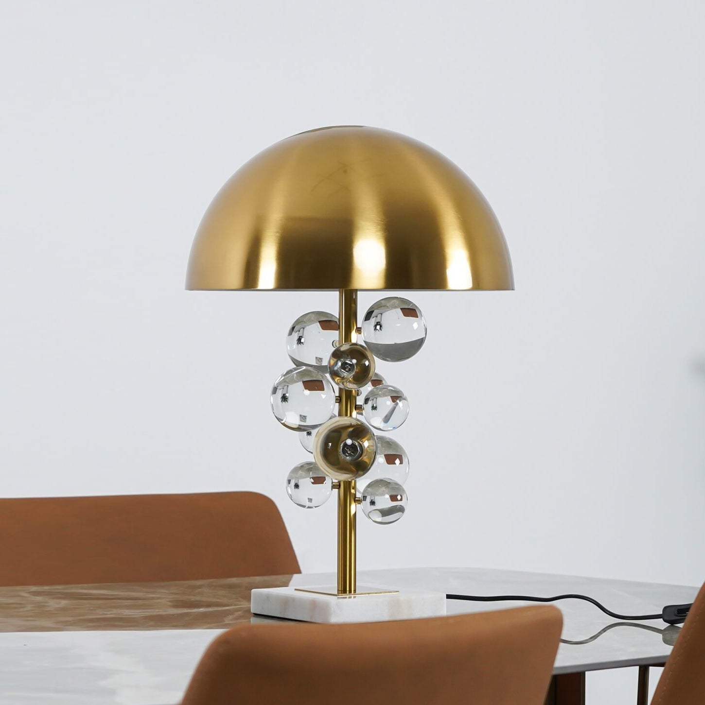 Globo glass sphere table lamp glowing on a marble base