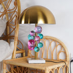 Globo lamp glass spheres glowing above a white marble base
