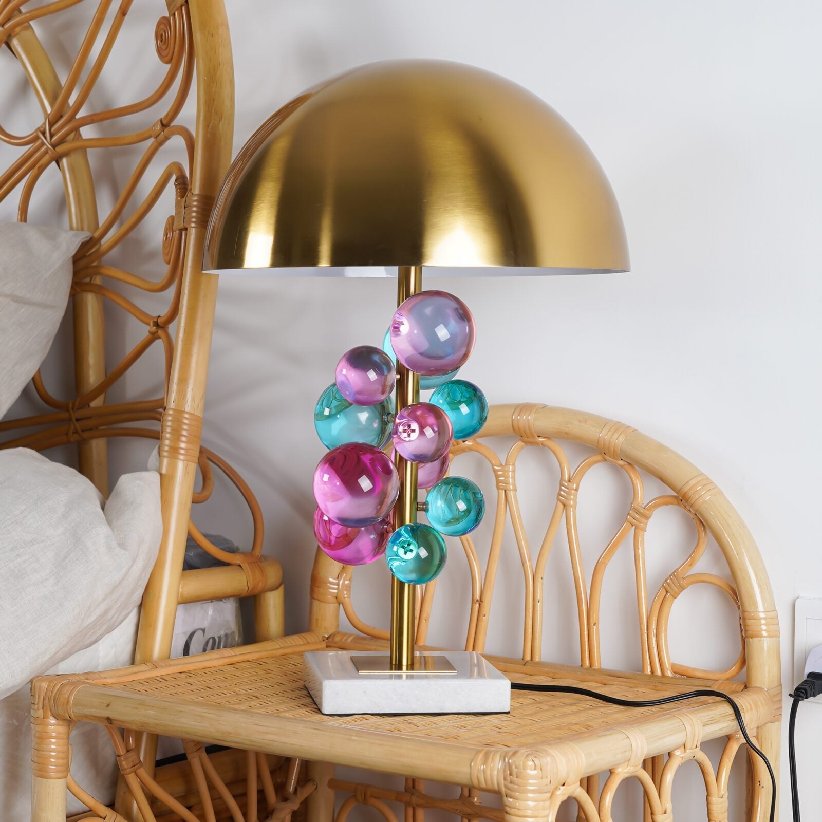 Globo lamp glass spheres glowing above a white marble base