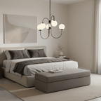 Gold gooseneck chandelier with white glass globes lit warm