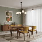 Black gooseneck chandelier glowing softly over a table