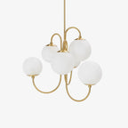 Wrought-iron gooseneck chandelier glowing over a dining table