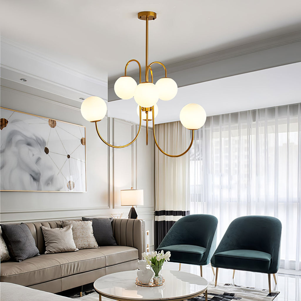 Gooseneck chandelier with curved iron arms over a dining space