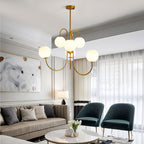 Gooseneck chandelier with curved iron arms over a dining space