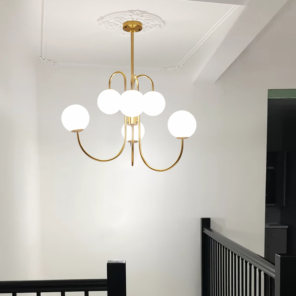 Gooseneck chandelier lighting a contemporary dining room