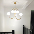Gooseneck chandelier lighting a contemporary dining room