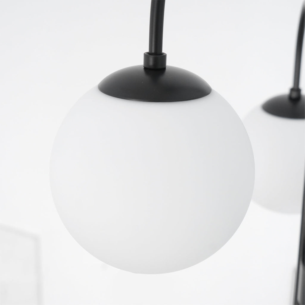 Gooseneck chandelier lighting a mid-century modern interior