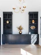 Gooseneck chandelier with curved arms glowing in a living room