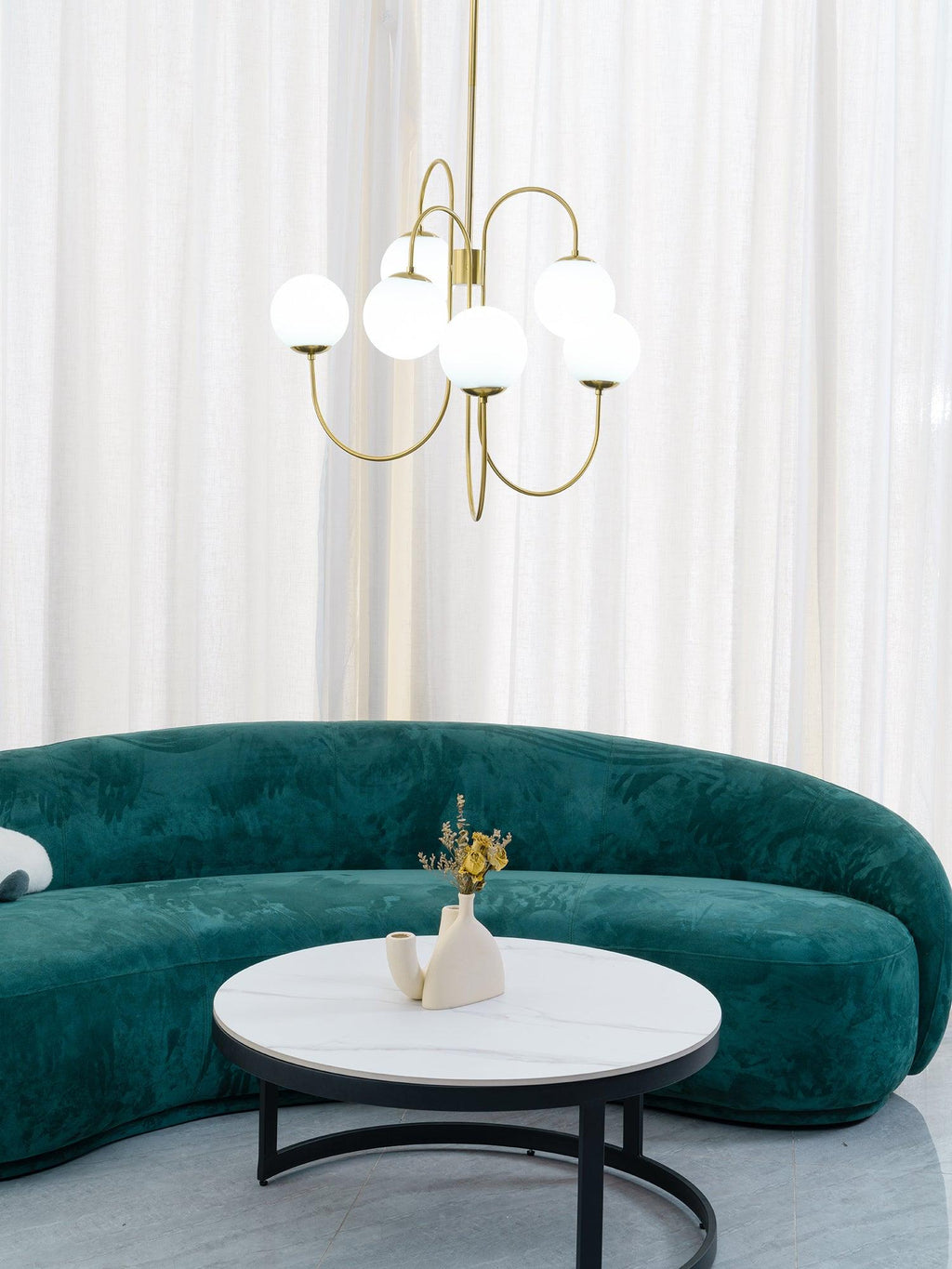 Gooseneck chandelier with iron arms and clean white globes