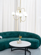 Gooseneck chandelier with iron arms and clean white globes