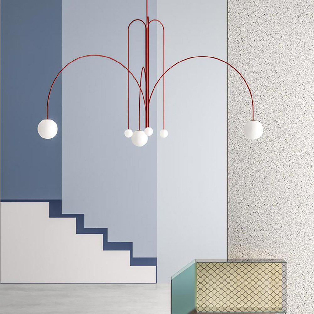 Six-head glass pendant light suspended above a dining table