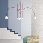 Six-head glass pendant light suspended above a dining table