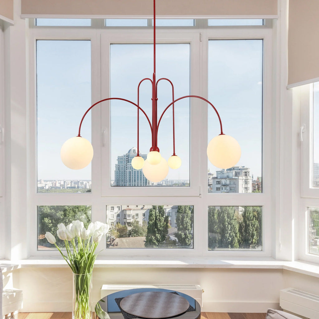 Six-head glass pendant light suspended in a contemporary room