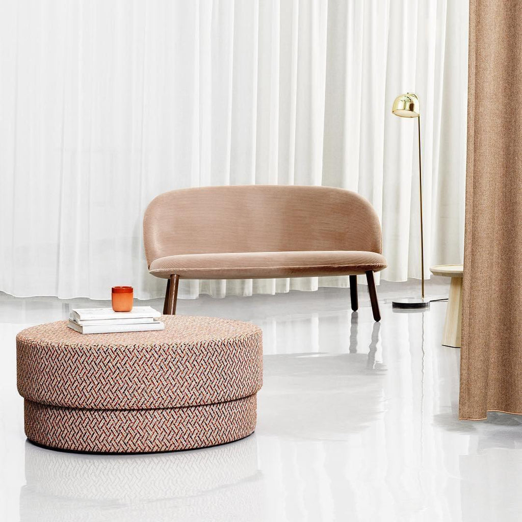 A curtained studio room holds this gold dome-shade Clérachic floor lamp behind a blush sofa and woven pouf.