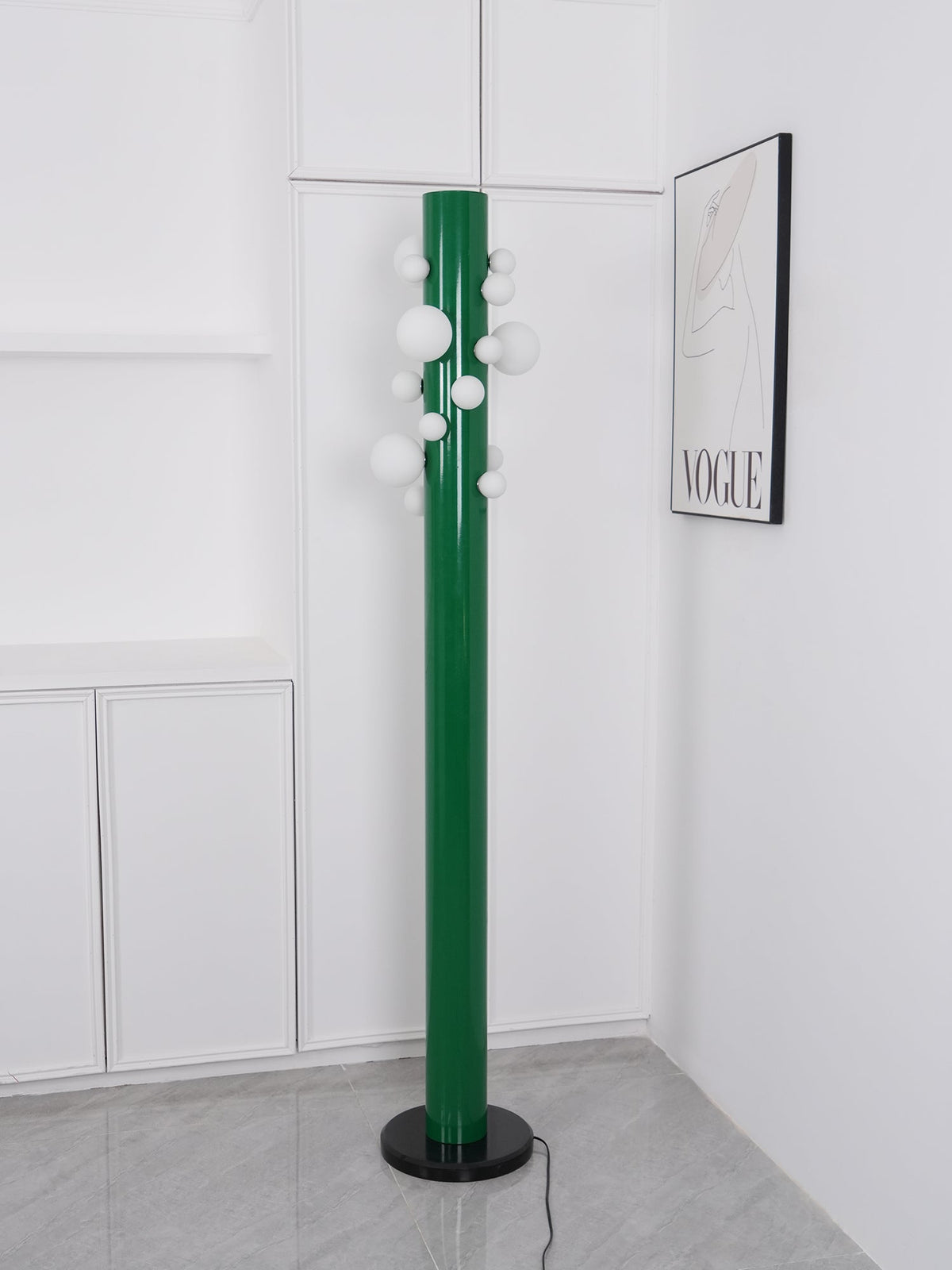Shot from a slightly different angle, the unlit green Clérachic floor lamp stands alone in the white corner nook.