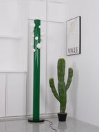 A tighter crop on its frosted globes shows the unlit green Clérachic floor lamp still paired with the cactus nearby.