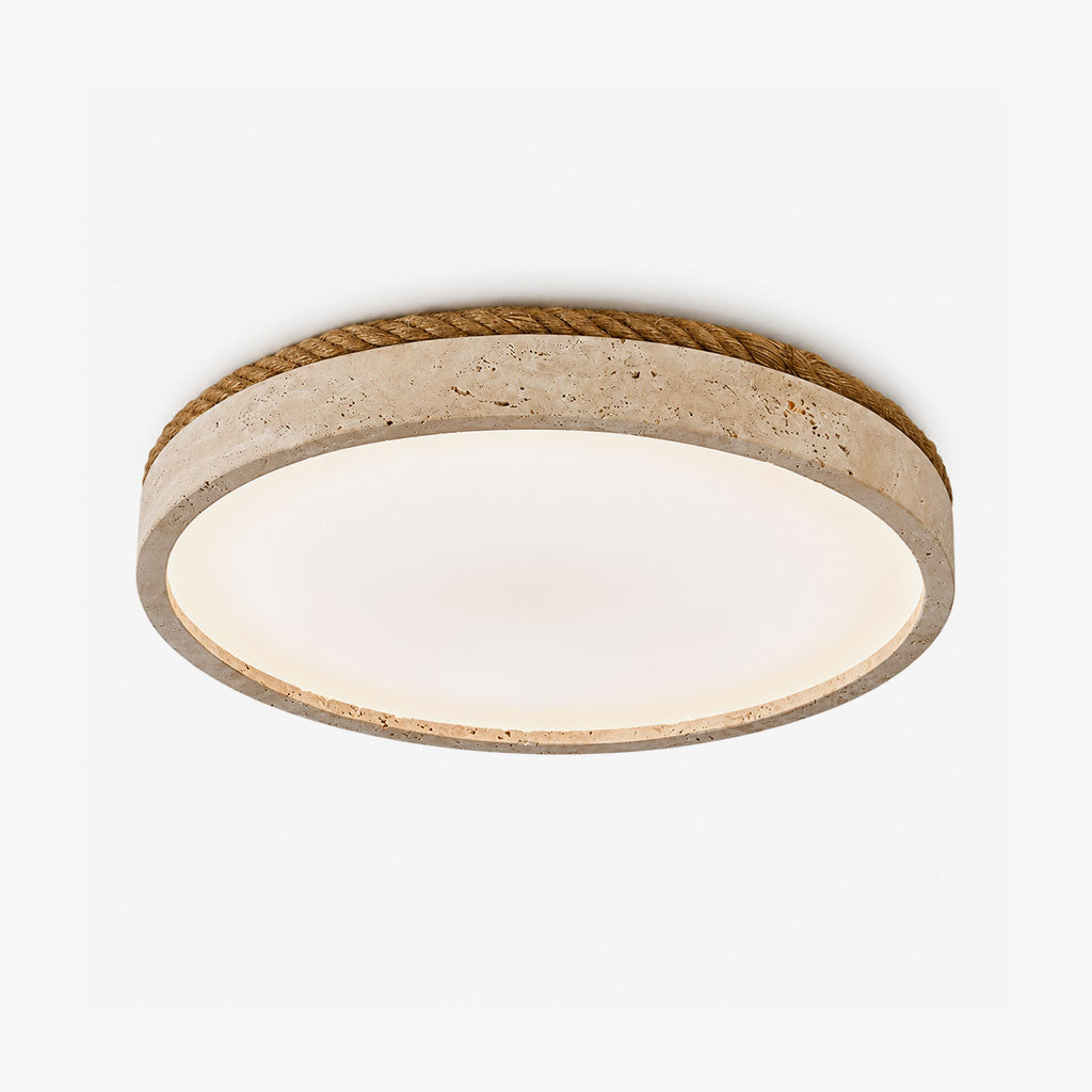 A Clérachic flush mount ceiling light in yellow travertine, its round rim wrapped in wound jute rope, shown at an angle on white.