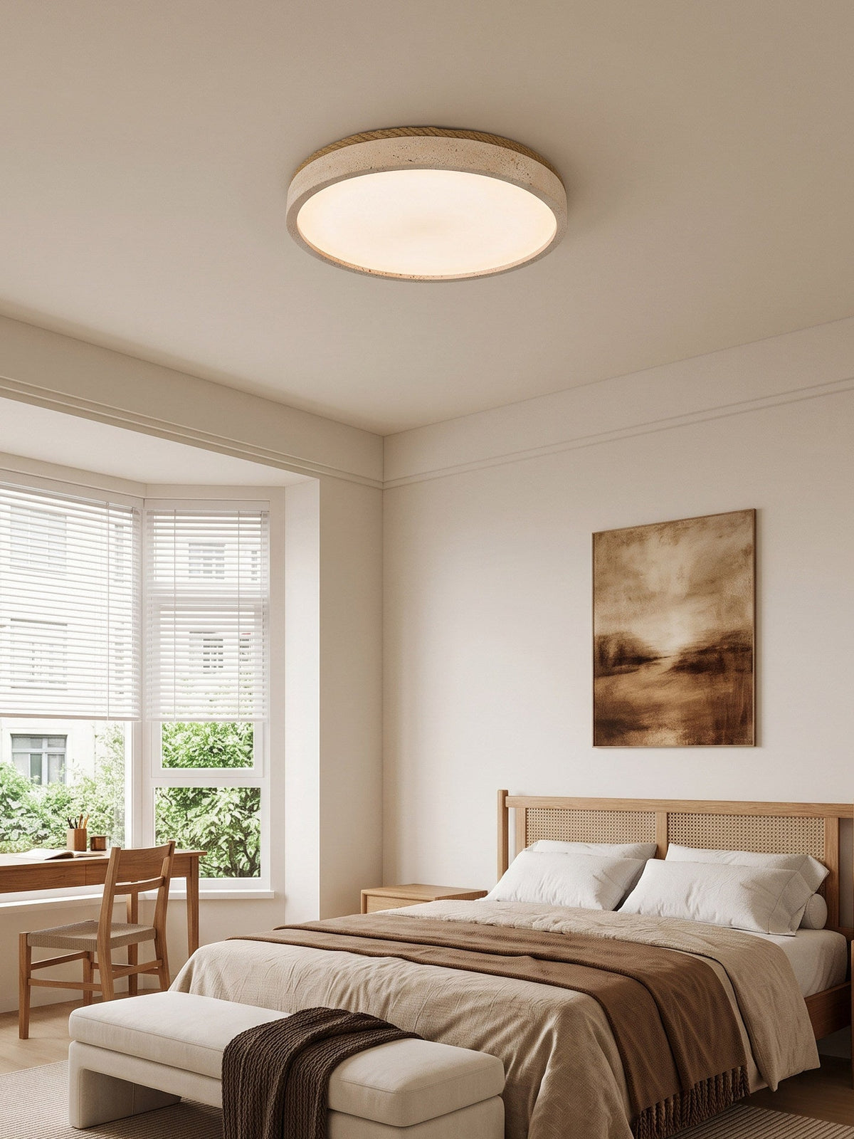 Above a bed with a woven bench at its foot, this round Clérachic ceiling light glows warm beside a bay window.
