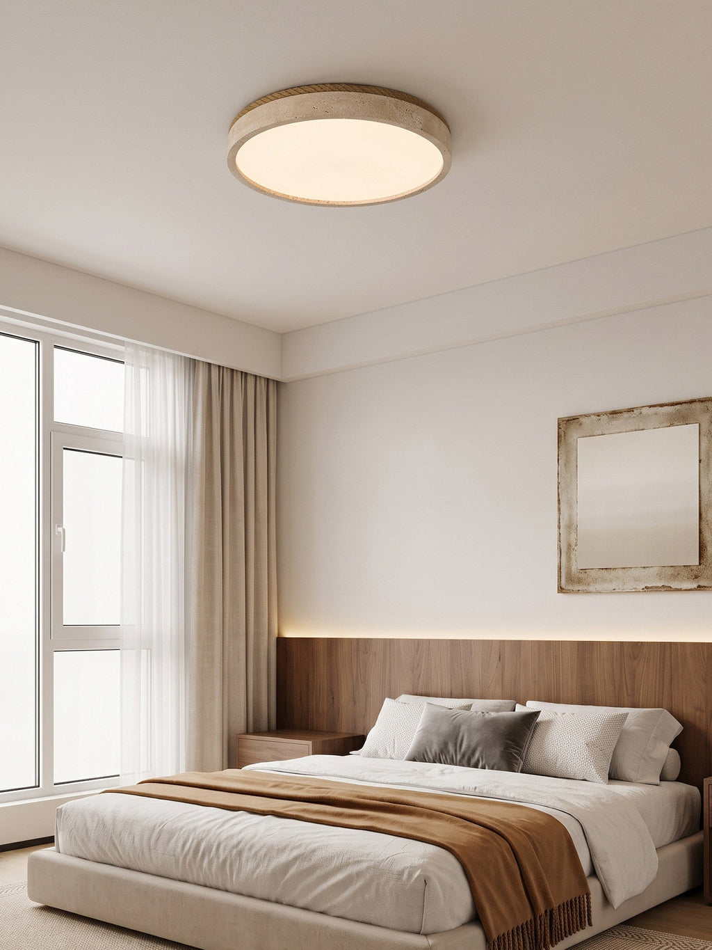 Sheer curtains drawn back reveal a bed below this round Clérachic ceiling light, set against a wood-panelled headboard.