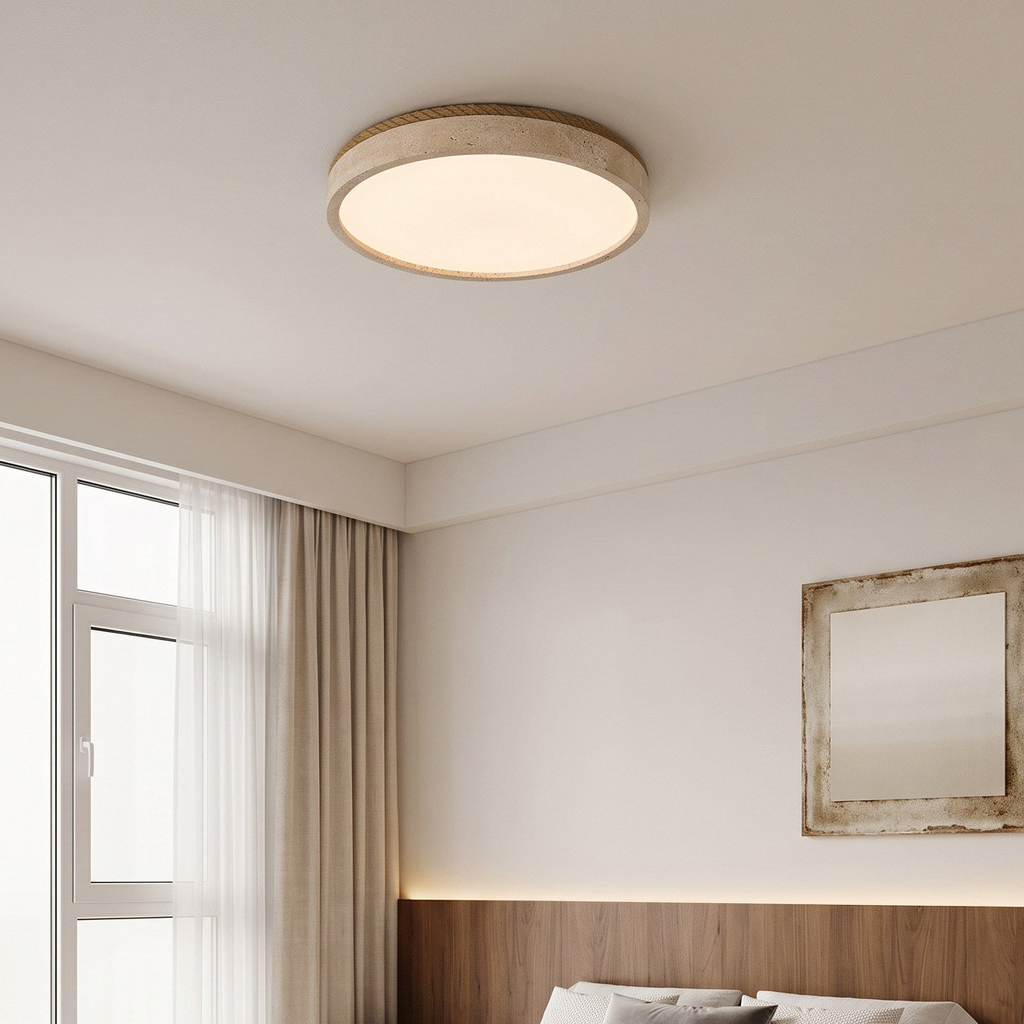 Lit above a curtained bedroom corner, this round Clérachic ceiling light sits near a weathered wall mirror.