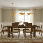 This Clérachic pendant trio hangs above a wood dining table in a sage-green room with cream curtains.