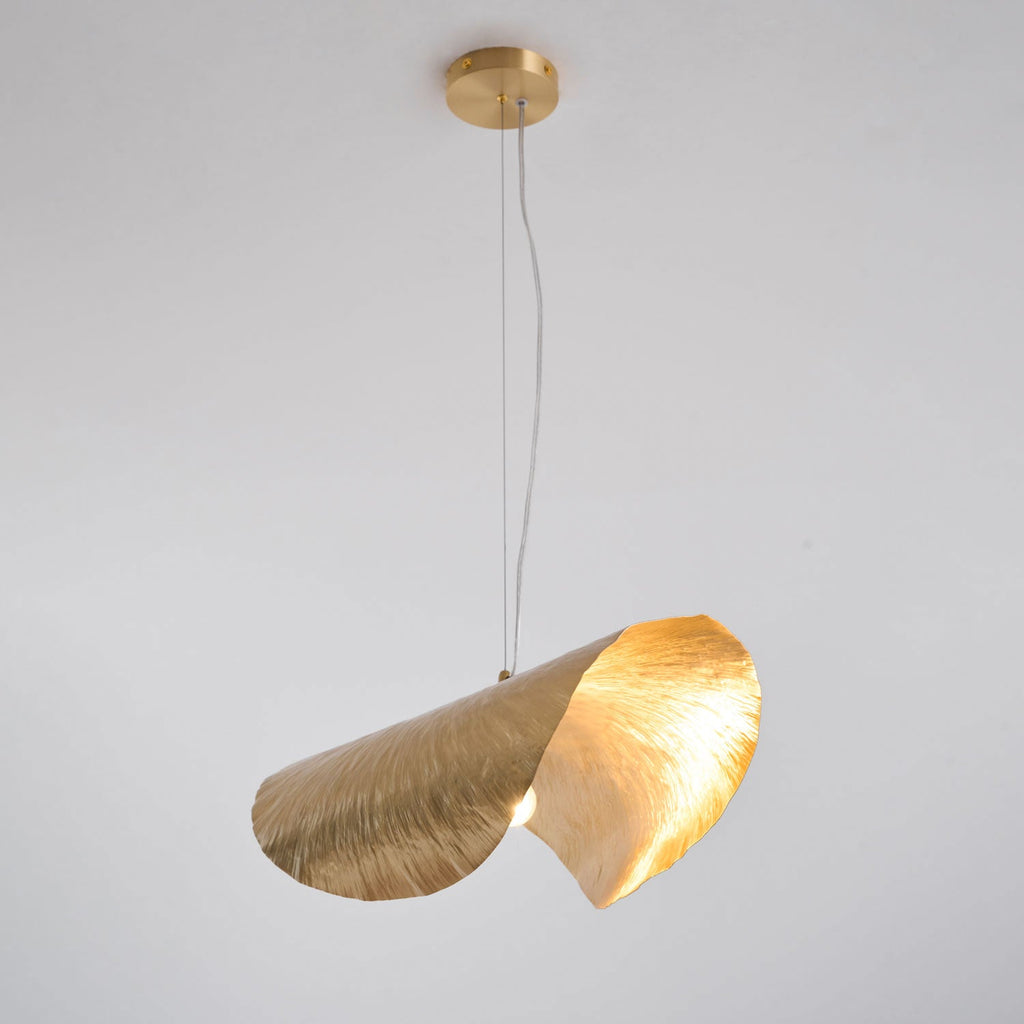 This Clérachic pendant hangs unlit on a short cord from its round brass ceiling canopy.