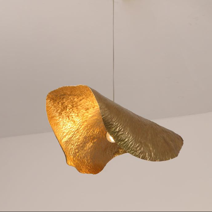 This Clérachic hammered brass shade is shown lit from an angled, close viewpoint.