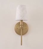 Front view of this Clérachic sconce in brass hardware, its alabaster cone shade shown against a plain backdrop.