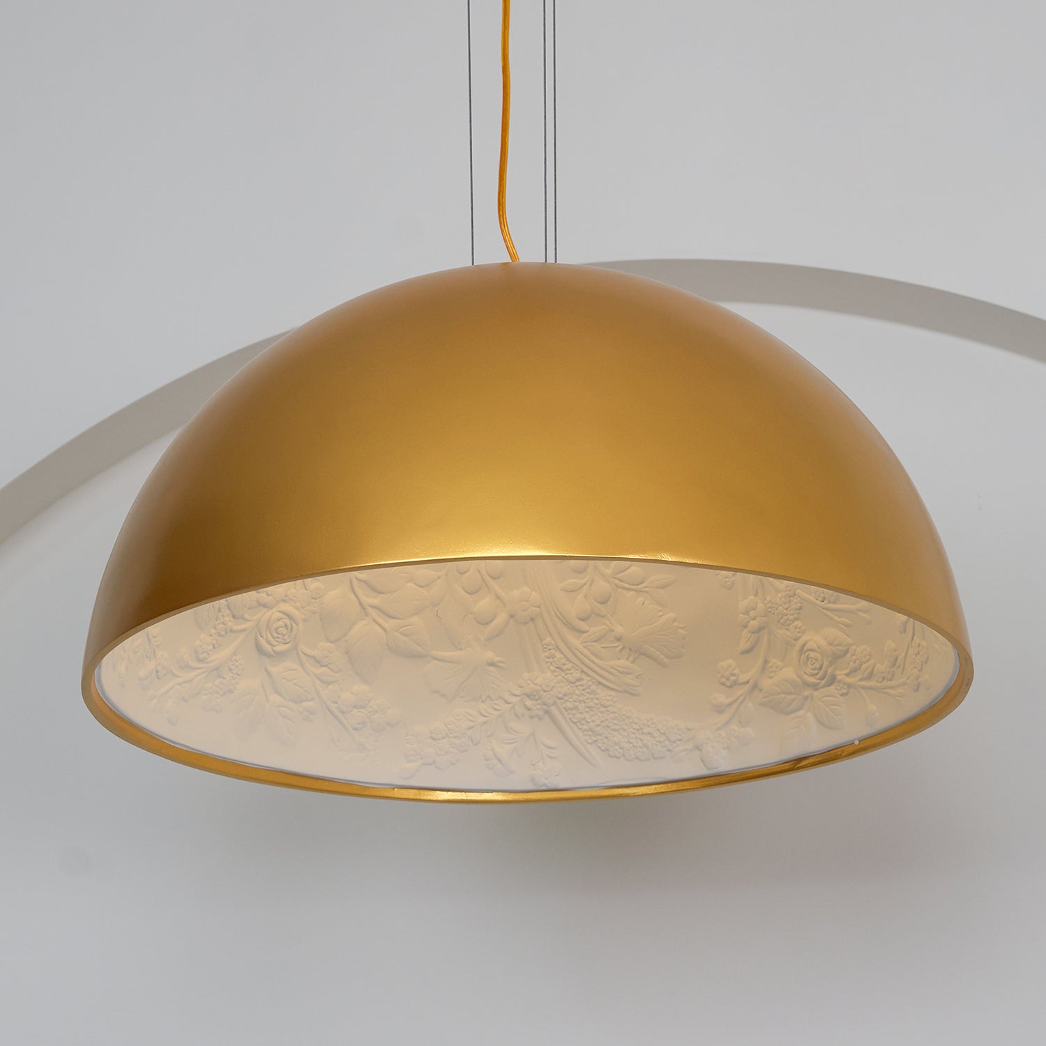 Hemisphere pendant light with warm glow in a neutral interior